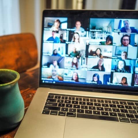 Online video meeting on a laptop