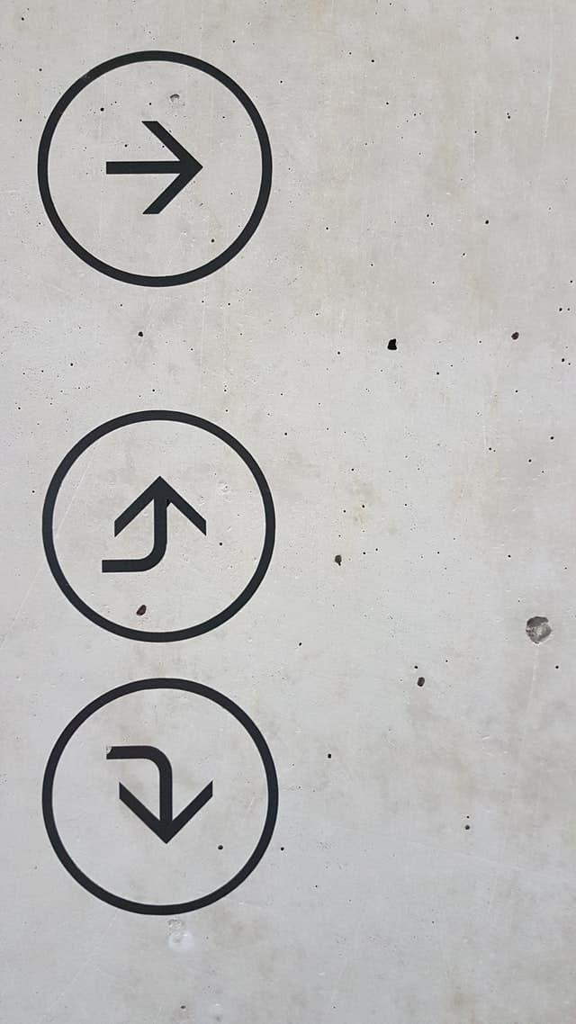 Arrows pointing in different directions on a wall